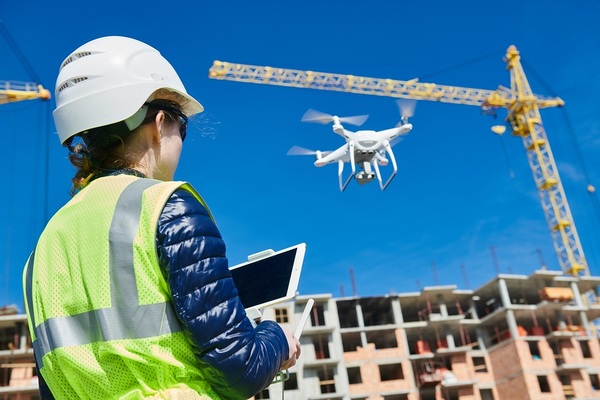 Construction worker flying a drone.